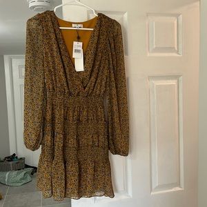 Socialite dress. Never worn. Size XS. Mustard color with floral details.